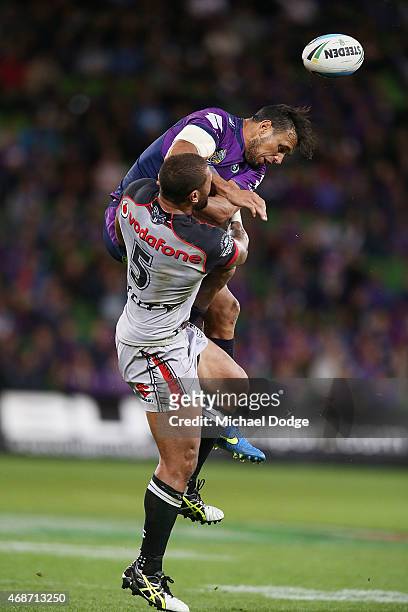 Will Chambers of the Storm and Manu Vatuvei of the Warriors compete for the ball during the round five NRL match between the Melbourne Storm and the...