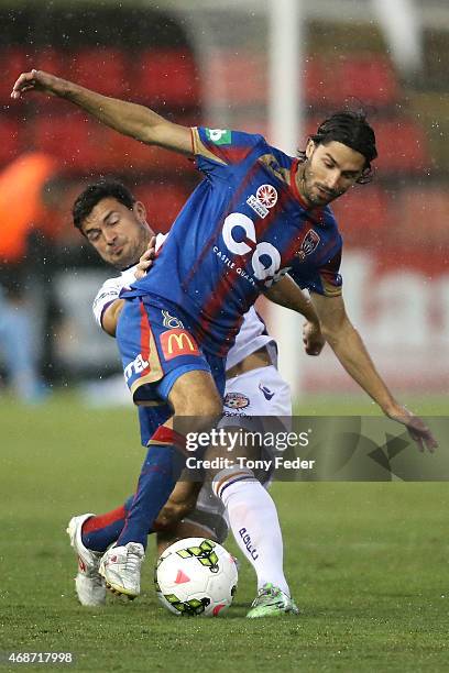 Zenon Caravella of the Jets contests the ball with his Glory opponent during the round 24 A-League match between the Newcastle Jets and Perth Glory...