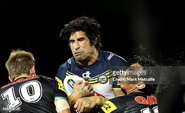 James Tamou of the Cowboys is tackled by Jeremy Latimore and Sika Manu of the Panthers during the round five NRL match between the Penrith Panthers...