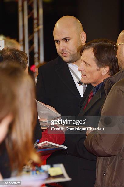 Viggo Mortensen signs autographs while arriving at 'The Two Faces of January' premiere during 64th Berlinale International Film Festival at Zoo...