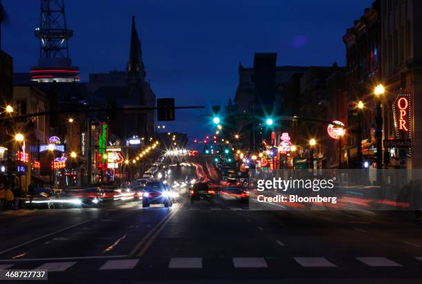 Cars drive down Broadway at night in downtown Nashville, Tennessee, U.S., on Saturday, Feb. 8, 2014. Tennessee's state capital, known as the home of...