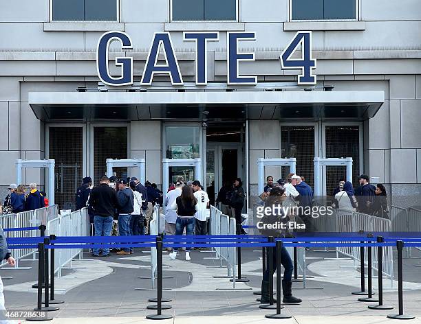 Fans line up to enter Gate 4 before the game between the New York Yankees and the Toronto Blue Jays on Opening Day on April 6, 2015 at Yankee Stadium...