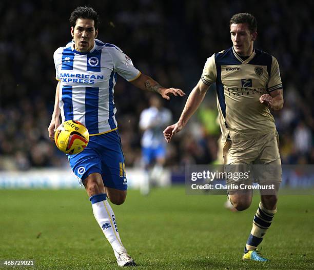 Leonardo Ulloa of Brighton battles with Jason Pearce of Leeds for the ball during the Sky Bet Championship match between Brighton & Hove Albion and...