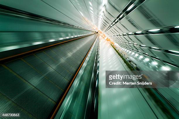 underground pedestrian escalator - travolator stock-fotos und bilder