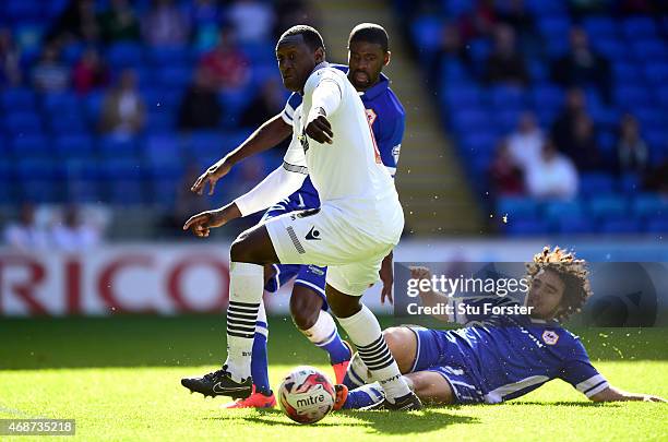 Bolton player Emile Heskey is challenged by Bruno Ecuele - Manga and Fabio Da Silva of Cardiff during the Sky Bet Championship match between Cardiff...