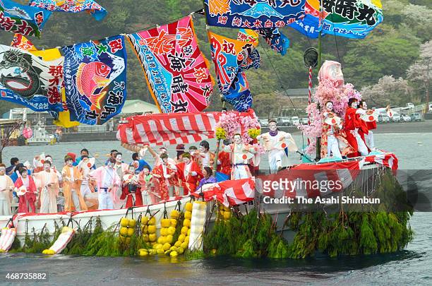 Fishermen and boys dressed and make-up as women dance on a decorated boat during annual Ose Festival at Suruga Bay on April 4, 2015 in Numazu,...