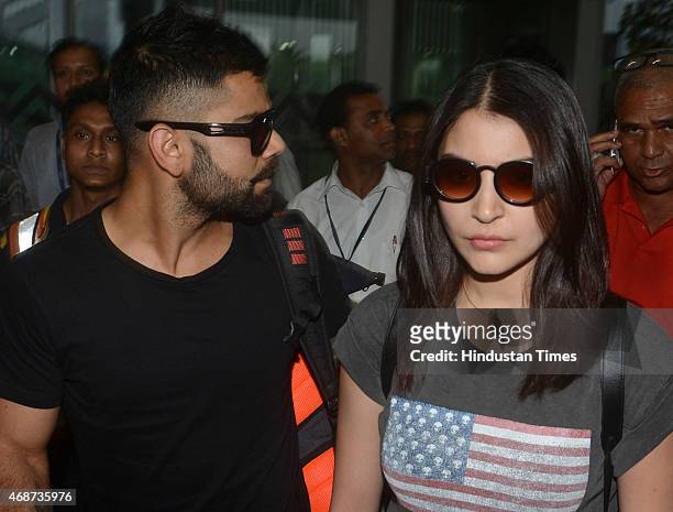 Bollywood actress Anushka Sharma and Indian cricketer Virat Kohli arrive at NSCBIA, Dum Dum Airport on April 6, 2015 in Kolkata, India. Bollywood...