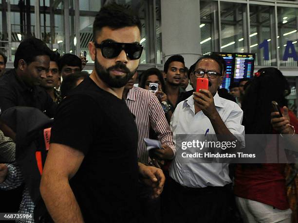 Indian cricketer Virat Kohli arrive with his girlfriend and Bollywood actress Anushka Sharma at NSCBIA, Dum Dum Airport on April 6, 2015 in Kolkata,...