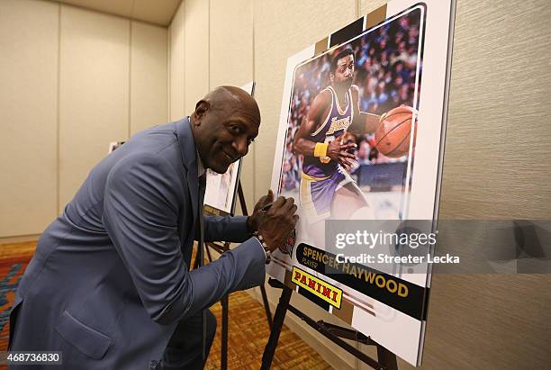 Spencer Haywood signs a print ahead of the Naismith Memorial Basketball Hall Of Fame 2014 Class Announcement at the JW Marriott on April 6, 2015 in...