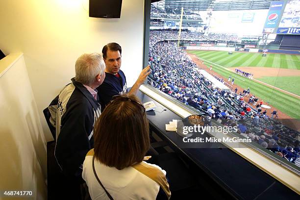 Wisconsin Governor Scott Walker stands in a executive press box before the start of the game between the Colorado Rockies and the Milwaukee Brewers...