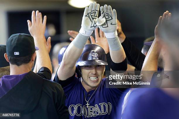 Corey Dickerson of the Colorado Rockies celebrates after hitting a two run homer in the top of the first inning against the Milwaukee Brewers during...