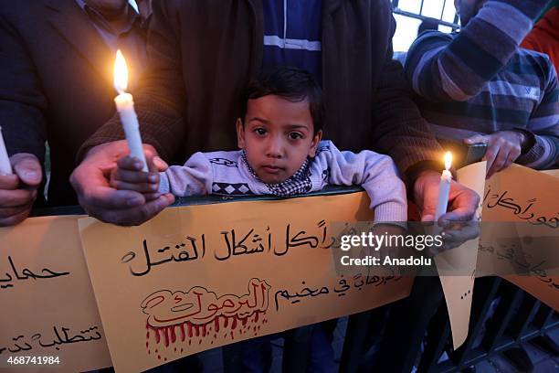 Palestinians, demanding the protection of Palestinian refugees and ending the clashes at Yarmouk Refugee Camp, stage a demonstration in Gaza city,...