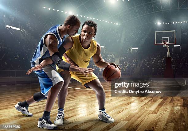 one on one basketball game in the spotlight - basket ball player stock pictures, royalty-free photos & images