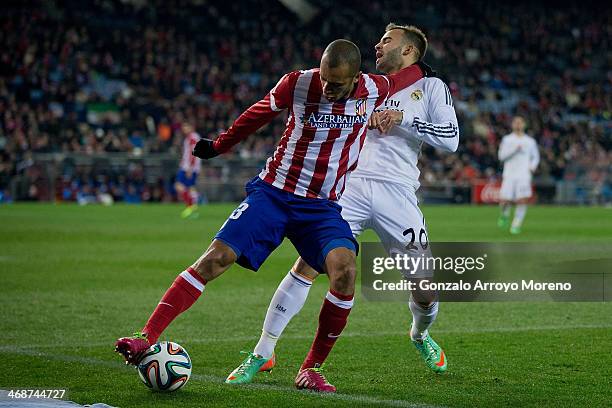 Joao Miranda of Atletico de Madrid holds Jese Rodriguez of Real Madrid CF during the Copa del Rey semi-final second leg match between Club Atletico...