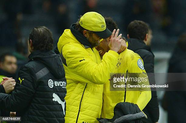 Head coach Juergen Klopp of Borussia Dortmund hugs Pierre-Emerick Aubameyang during the DFB Cup quarterfinal match between Eintracht Frankfurt and...