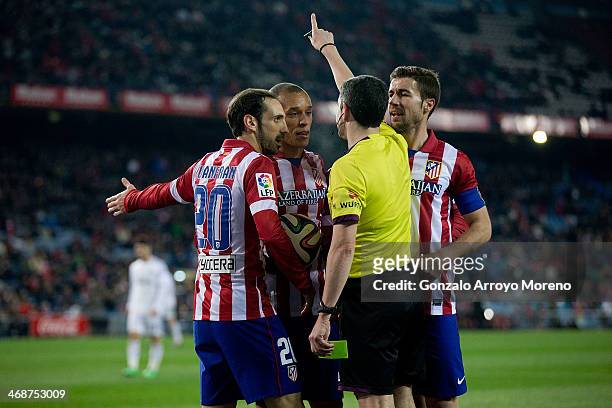 Joao Miranda of Atletico de Madrid and his teammates Juan Francisco Torres alias Juanfran and Gabi Fernandez argue with referee Undiano Mallenco...