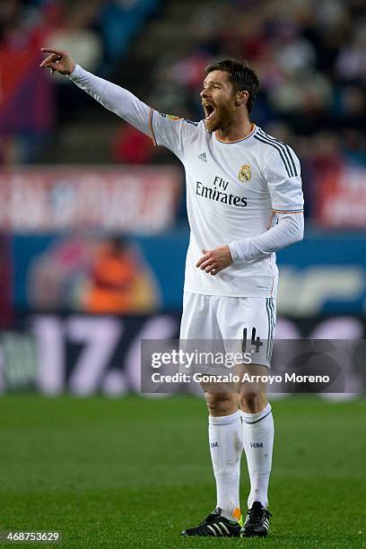Xabi Alonso of Real Madrid CF gives instructions to his teammates during the Copa del Rey semi-final second leg match between Club Atletico de Madrid...