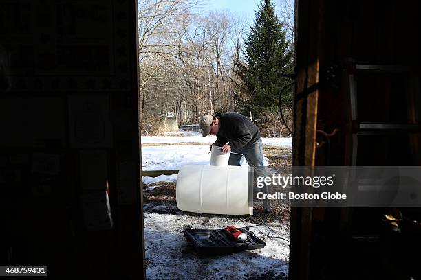 Sean Davan, owner of Woodville Maples in Hopkinton, works at his sugar house getting ready for maple sugaring season. The International Maple Syrup...