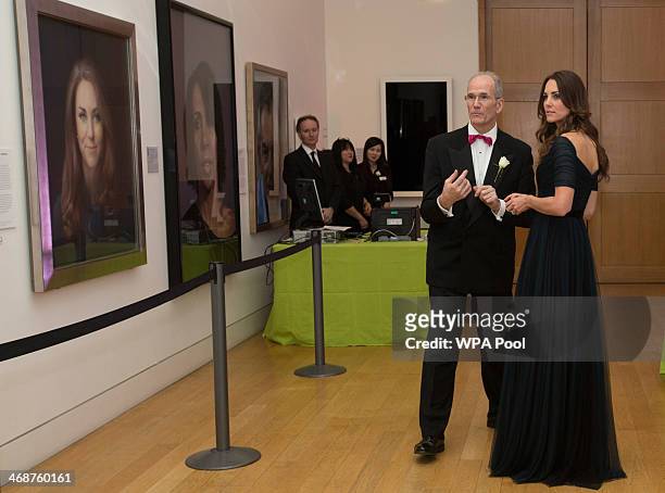 Catherine, Duchess of Cambridge is congratulated by the Director of the National Portrait Gallery Sandy Nairne as she attends The Portrait Gala 2014:...