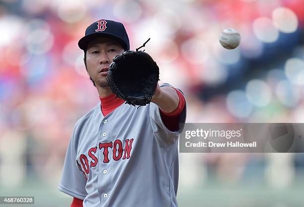 Junichi Tazawa of the Boston Red Sox catches the ball in the eighth inning against the Philadelphia Phillies during Opening Day at Citizens Bank Park...