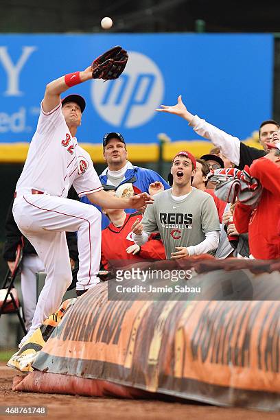 Jay Bruce of the Cincinnati Reds climbs the tarp in foul territory to make a catch for the last out of the game against the Pittsburgh Pirates at...