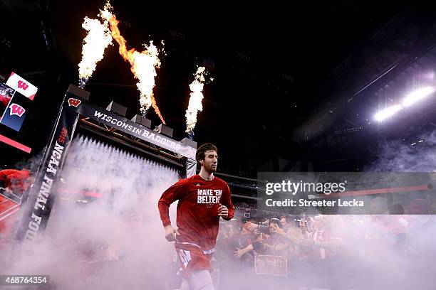 Frank Kaminsky of the Wisconsin Badgers runs out to the court before taking on the Duke Blue Devils in the NCAA Men's Final Four National...