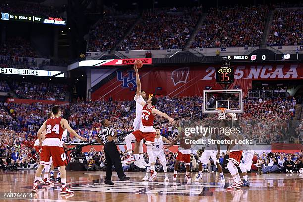 Jahlil Okafor of the Duke Blue Devils tips off against Frank Kaminsky of the Wisconsin Badgers to start the first half of the NCAA Men's Final Four...