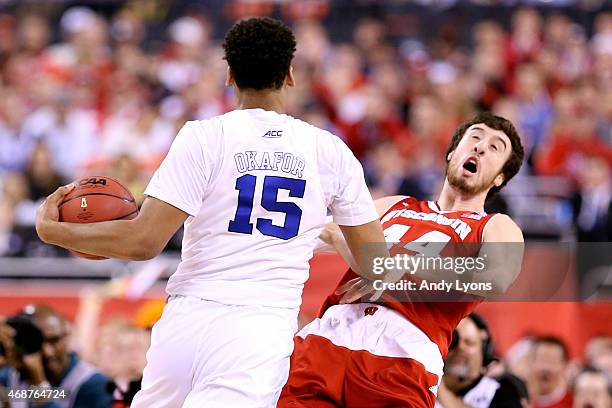 Jahlil Okafor of the Duke Blue Devils collides with Frank Kaminsky of the Wisconsin Badgers and is called for an offensive foul in the first half...