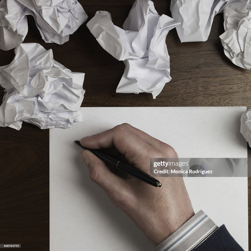 Man starts to write on blank paper.