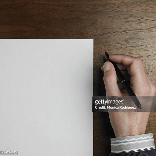 man's hand holding pen - person holding blank piece of paper stock pictures, royalty-free photos & images