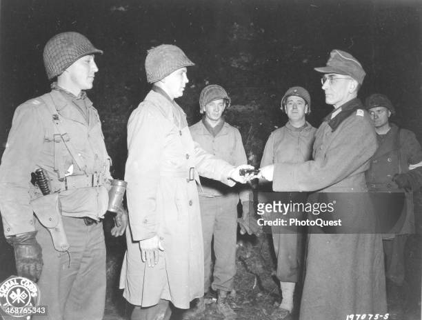 The German colonel commanding Fort San Quentin formally surrenders his garrison to American Infantry officers from the 2nd BN, 11th Inf Regt, 5th Inf...
