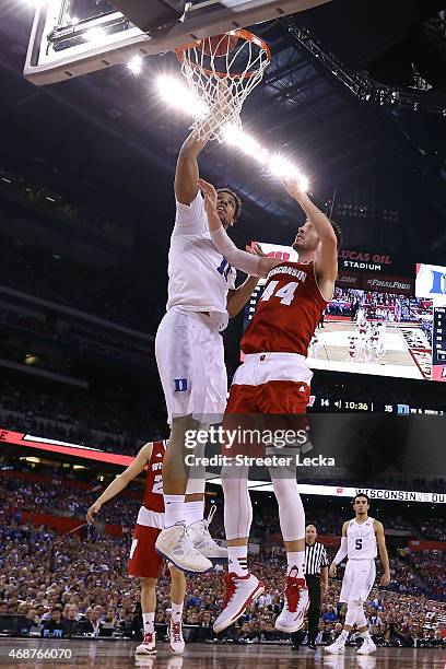 Jahlil Okafor of the Duke Blue Devils drives to the basket against Frank Kaminsky of the Wisconsin Badgers in the first half during the NCAA Men's...