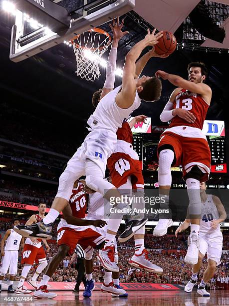 Grayson Allen of the Duke Blue Devils drives to the basket against Frank Kaminsky and Duje Dukan of the Wisconsin Badgers in the second half during...