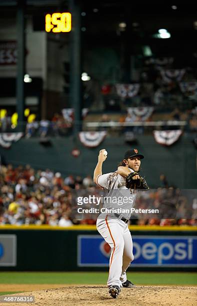 Starting pitcher Madison Bumgarner of the San Francisco Giants warms up in between innings under the pace of play clock during the Opening Day MLB...