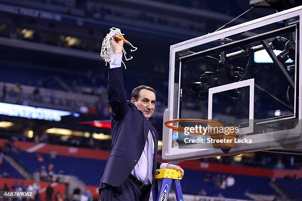 Head coach Mike Krzyzewski of the Duke Blue Devils cuts down the net after defeating the Wisconsin Badgers during the NCAA Men's Final Four National...