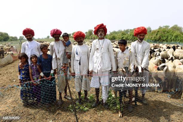 In this photograph taken on April 2 Indian nomadic shepherds pose for a photograph at their camp in Dhatir some 70 kms from New Delhi. Nomadic...