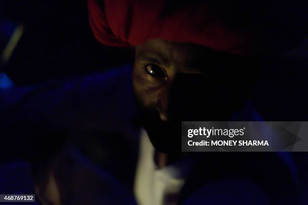 In this photograph taken on March 24 Indian nomadic shepherd Dhana Ram poses at his camp at Sikri in Faridabad some 50kms from New Delhi. Nomadic...