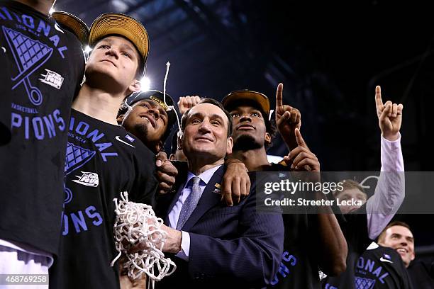 Head coach Mike Krzyzewski of the Duke Blue Devils watches "One Shining Moment" with his players Grayson Allen, Quinn Cook and Justise Winslow after...