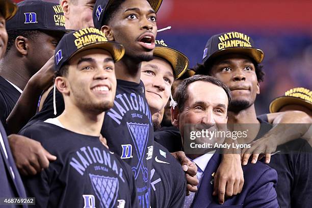 Head coach Mike Krzyzewski of the Duke Blue Devils watches "One Shining Moment" with his playersTyus Jones, Amile Jefferson, Grayson Allen and...