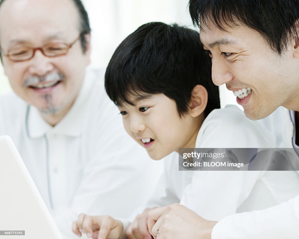 Father And Son Using Laptop