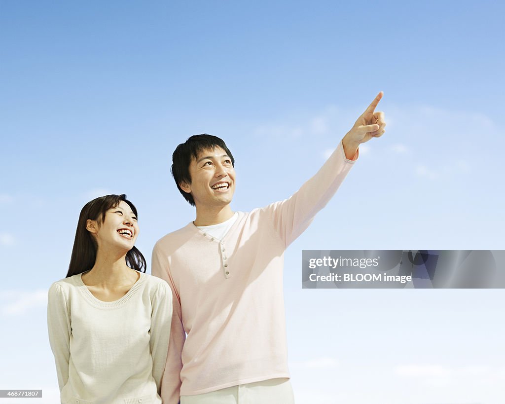 Happy Couple Looking At Sky