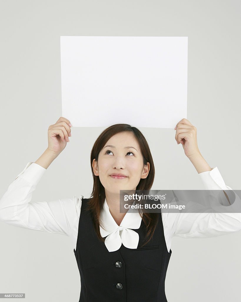 Businesswoman Holding Blank Placard