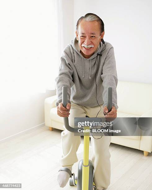 senior man cycling - exercise bike stock pictures, royalty-free photos & images