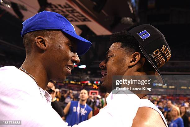 Quinn Cook of the Duke Blue Devils talks to former Duke basketball player Nolan Smith following their win against the Wisconsin Badgers during the...