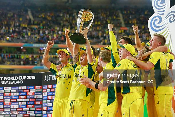 Australian captain Michael Clarke, Steven Smith and Australian players celebrate with the World Cup trophy as they celebrate after Australia won the...