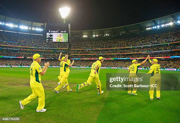 Steven Smith and James Faulkner of Australia and their teammates celebrate after winning the 2015 ICC Cricket World Cup final match between Australia...