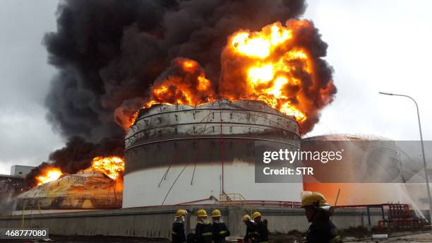 Firefighters battle a blaze after an explosion at a plant producing paraxylene - a chemical commonly known as PX - in Zhangzhou, east China's Fujian...