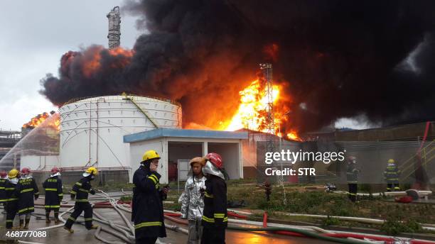 Firefighters battle a blaze after an explosion at a plant producing paraxylene - a chemical commonly known as PX - in Zhangzhou, east China's Fujian...