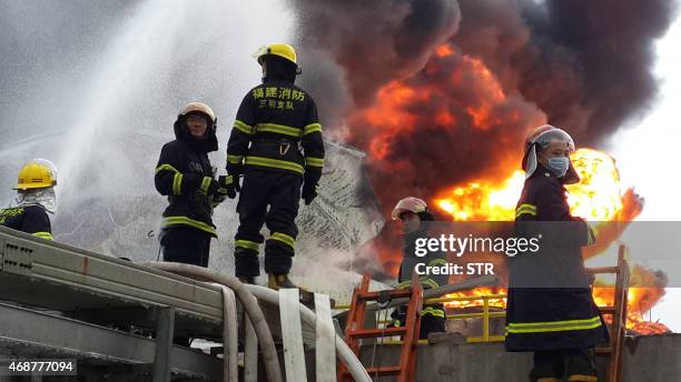 Firefighters battle a blaze after an explosion at a plant producing paraxylene - a chemical commonly known as PX - in Zhangzhou, east China's Fujian...