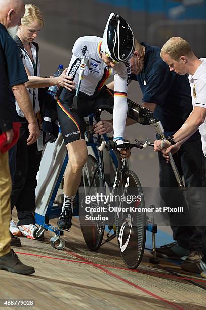 Rider Erich Winkler is helped by the German Head Coach Patrick Kromer into the startblock at the mens MC1 3km pursuit race on March 27, 2015 in...